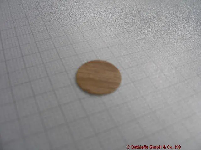 A sheet of lorraine walnut Dethleffs self-adhesive dot stickers on a transparent backing.