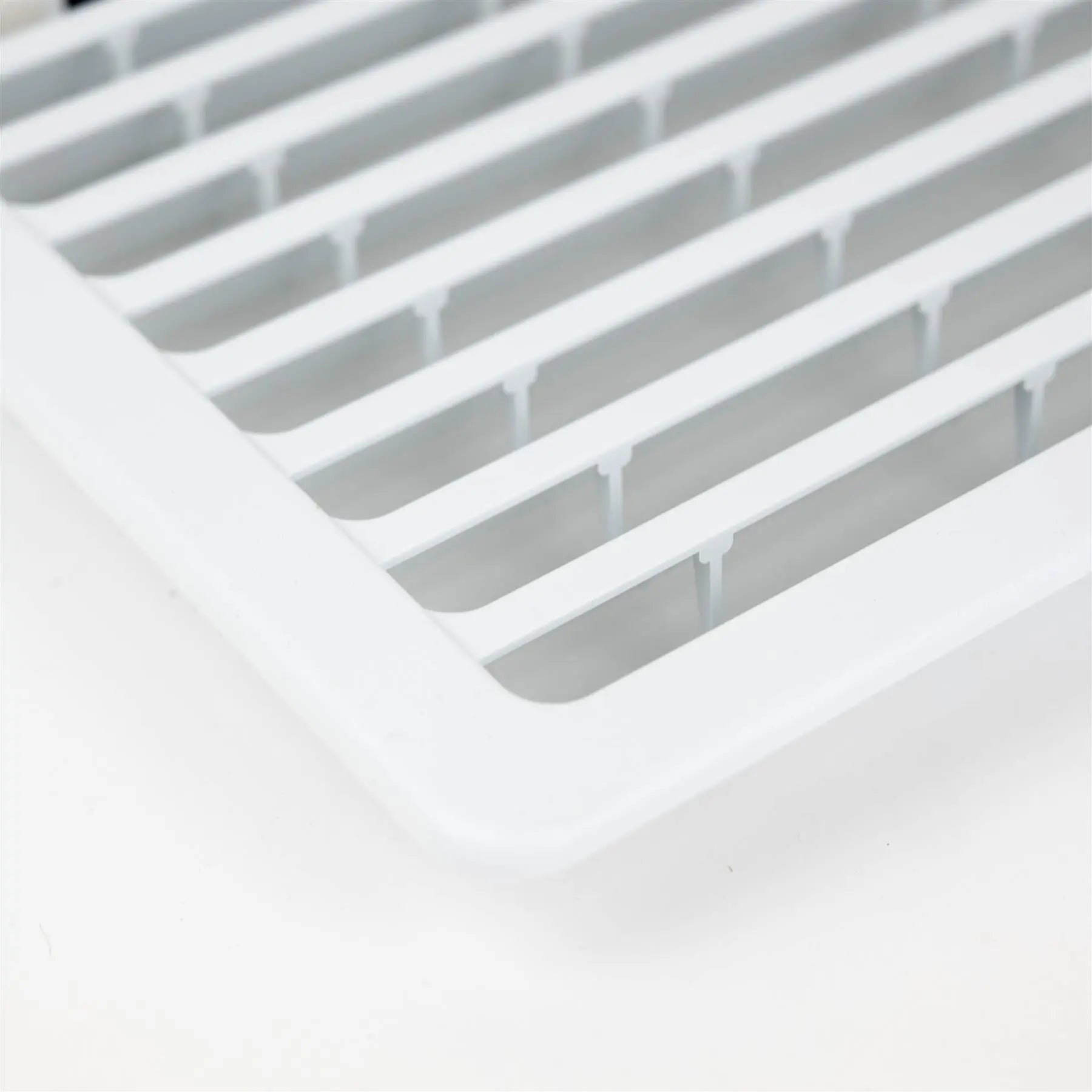 A white Dethleffs motorhome Thetford fridge ventilation grille.