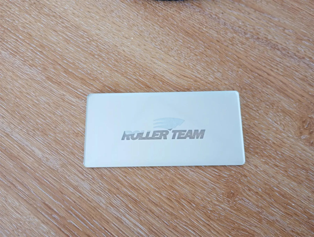 A chrome Roller Team motorhome logo step plate.