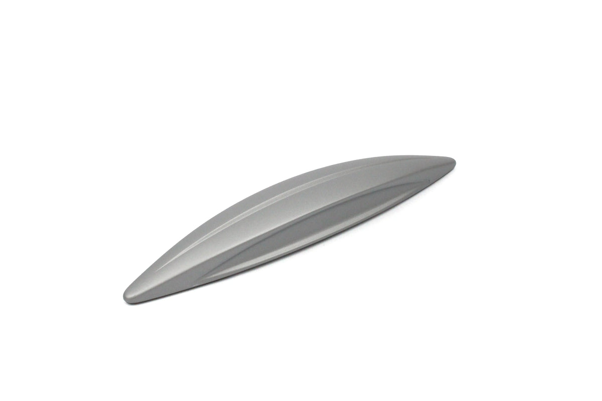A silver wing-shaped Roller Team motorhome cupboard door handle.