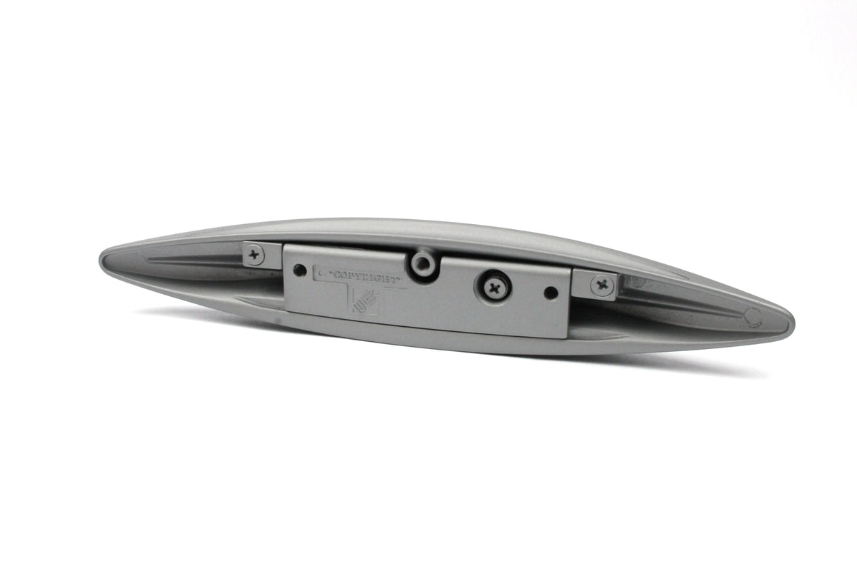 A silver wing-shaped Roller Team motorhome cupboard door handle.