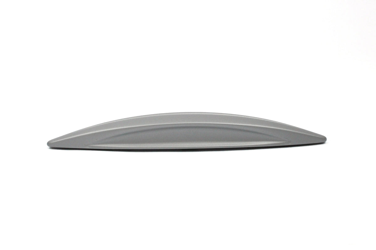 A silver wing-shaped Roller Team motorhome cupboard door handle.