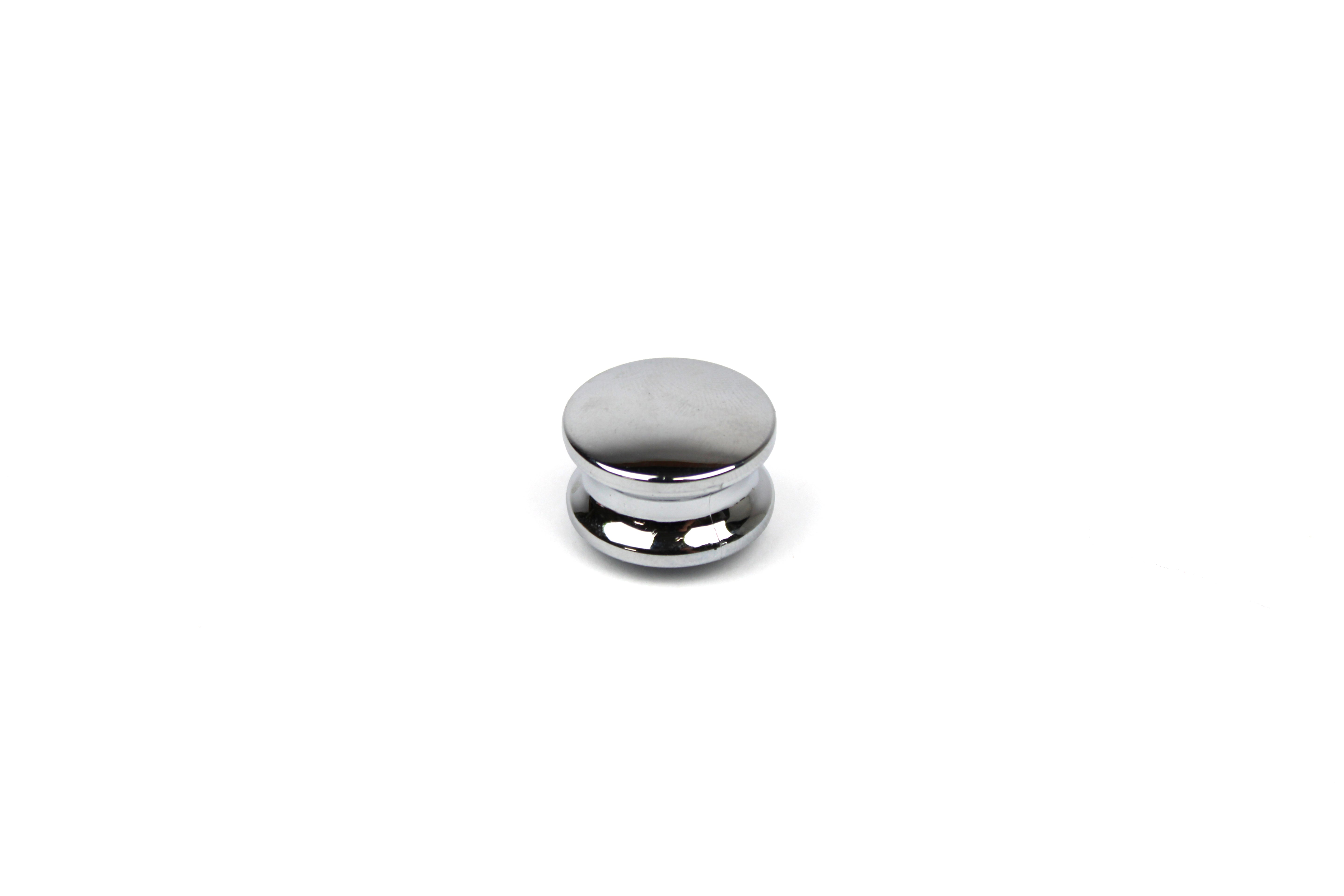Chrome push button knob on a white background