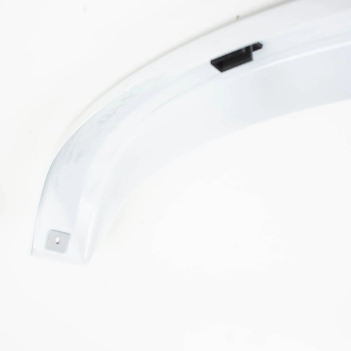 A white Dethleffs motorhome rear wheel arch trim.