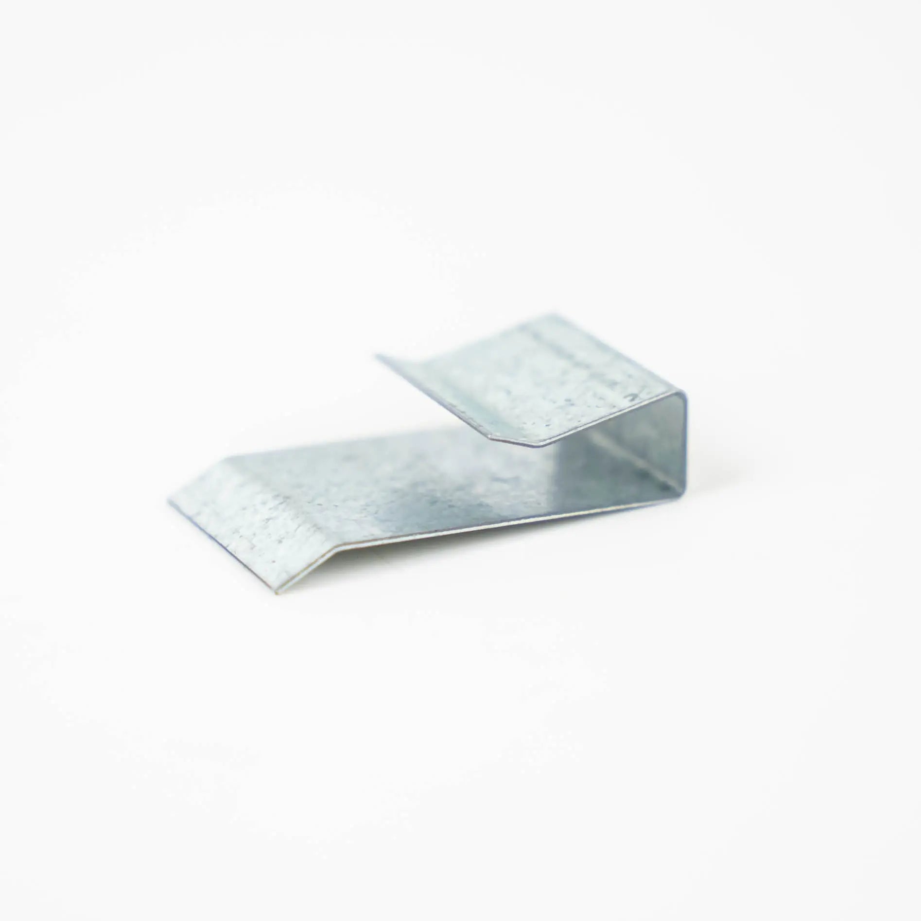 A silver metal Auto-Trail motorhome wheel arch clip.
