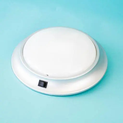 A white Roller Team circular florescent ceiling light.