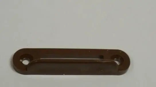 A black plastic Auto-Trail motorhome striker plate.