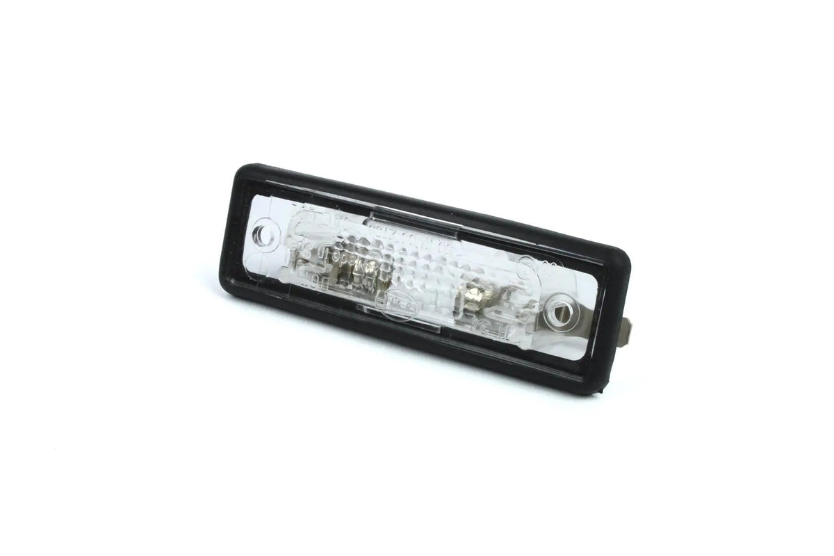 A clear Dethleffs motorhome rear number plate light with a black rim.