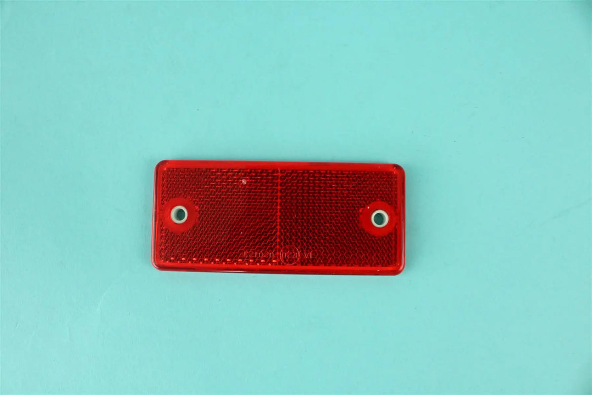 A red rectangular Roller Team motorhome reflector.