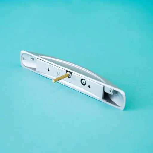 A silver arch-shaped Roller Team motorhome cupboard door handle.