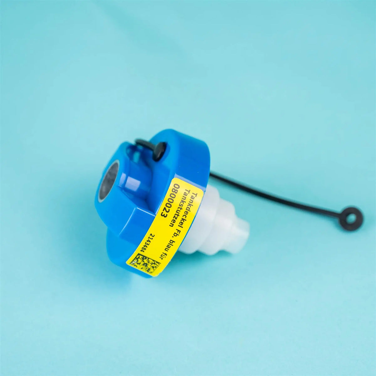 A blue and white Dethleffs motorhome tank cap and retainer strap.