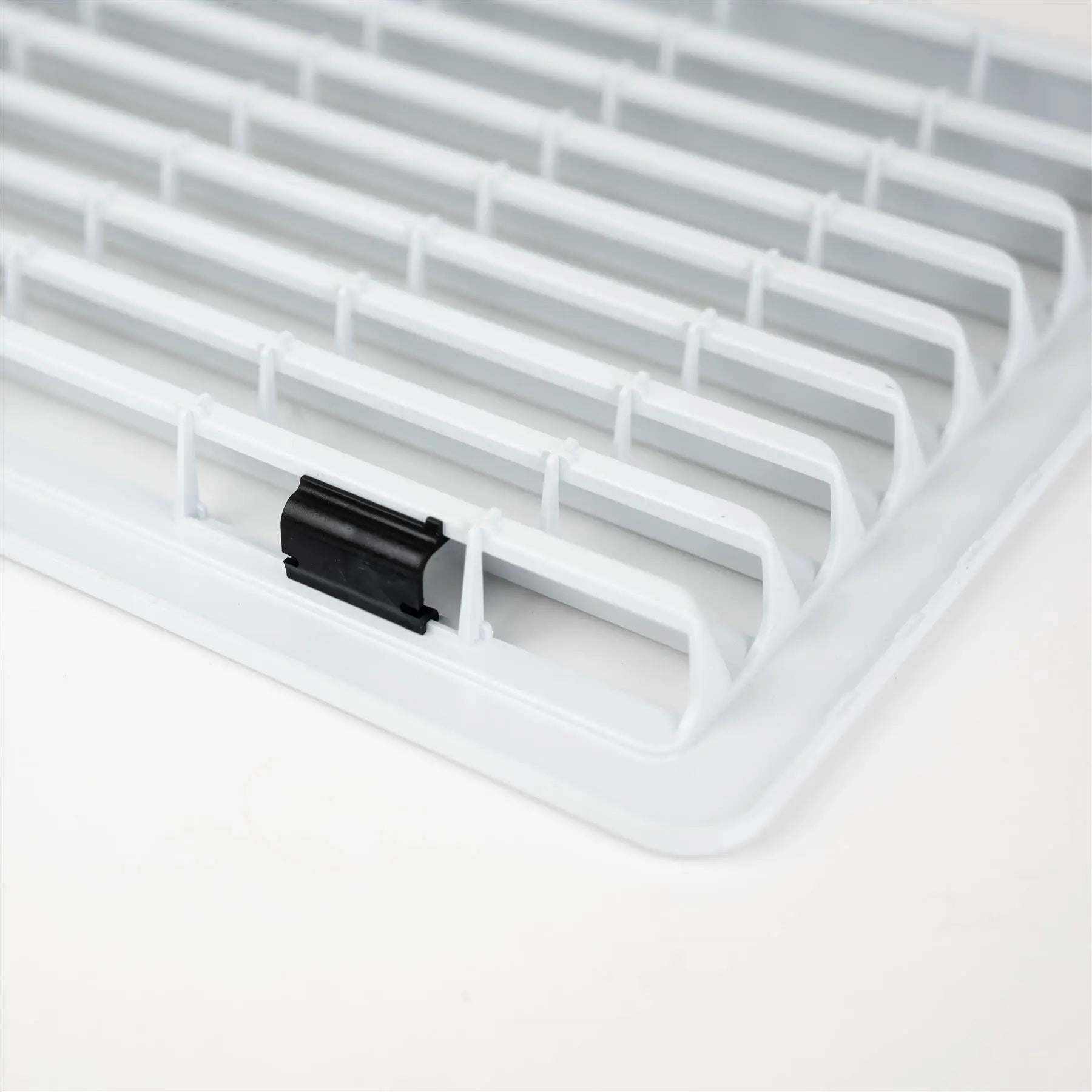 A white Dethleffs motorhome Thetford fridge ventilation grille.