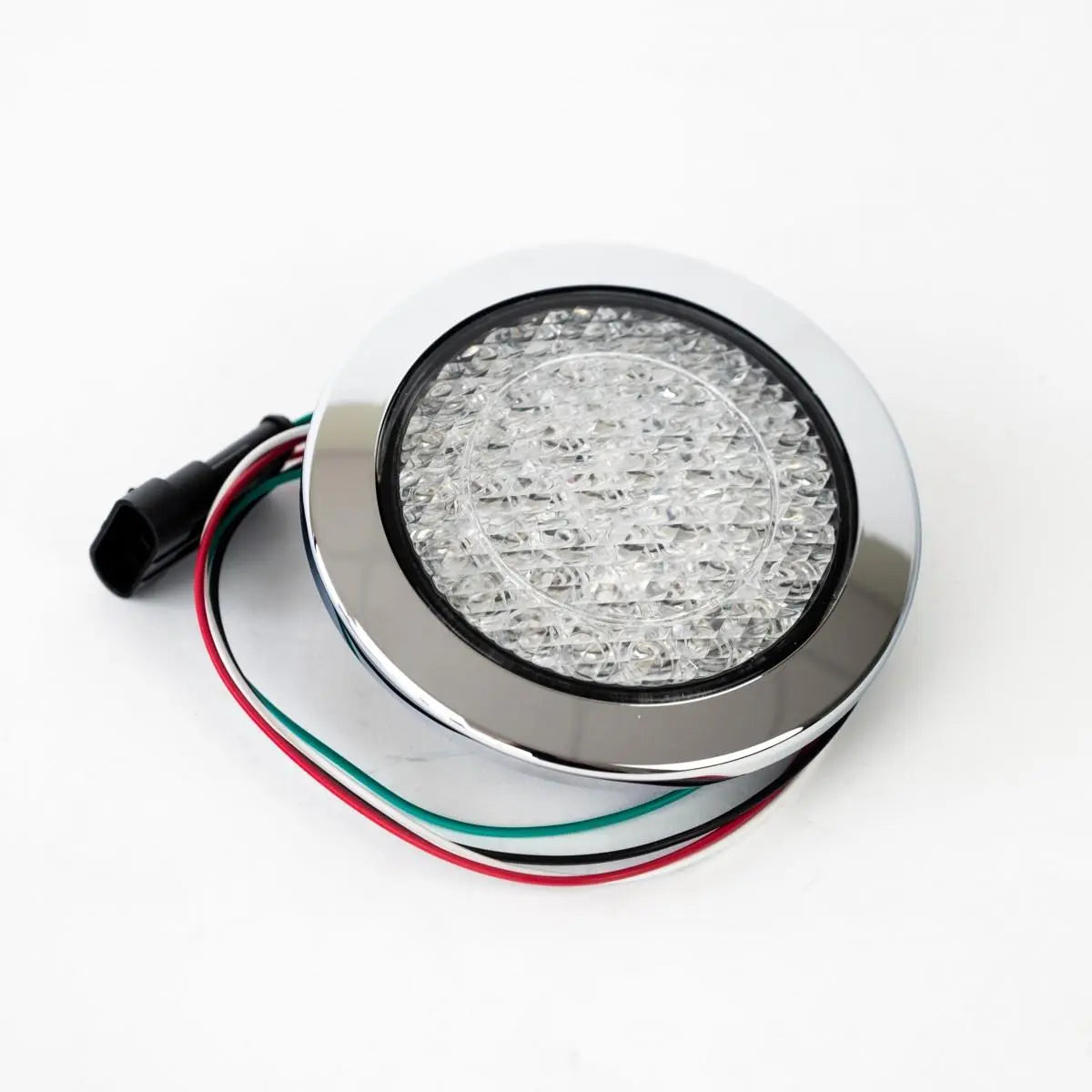 A clear Roller Team motorhome reverse light with a chrome bezel.