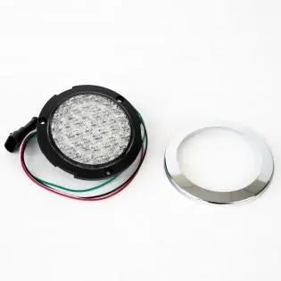 A clear Roller Team motorhome reverse light with a chrome bezel.