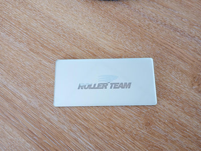 A chrome Roller Team motorhome logo step plate.