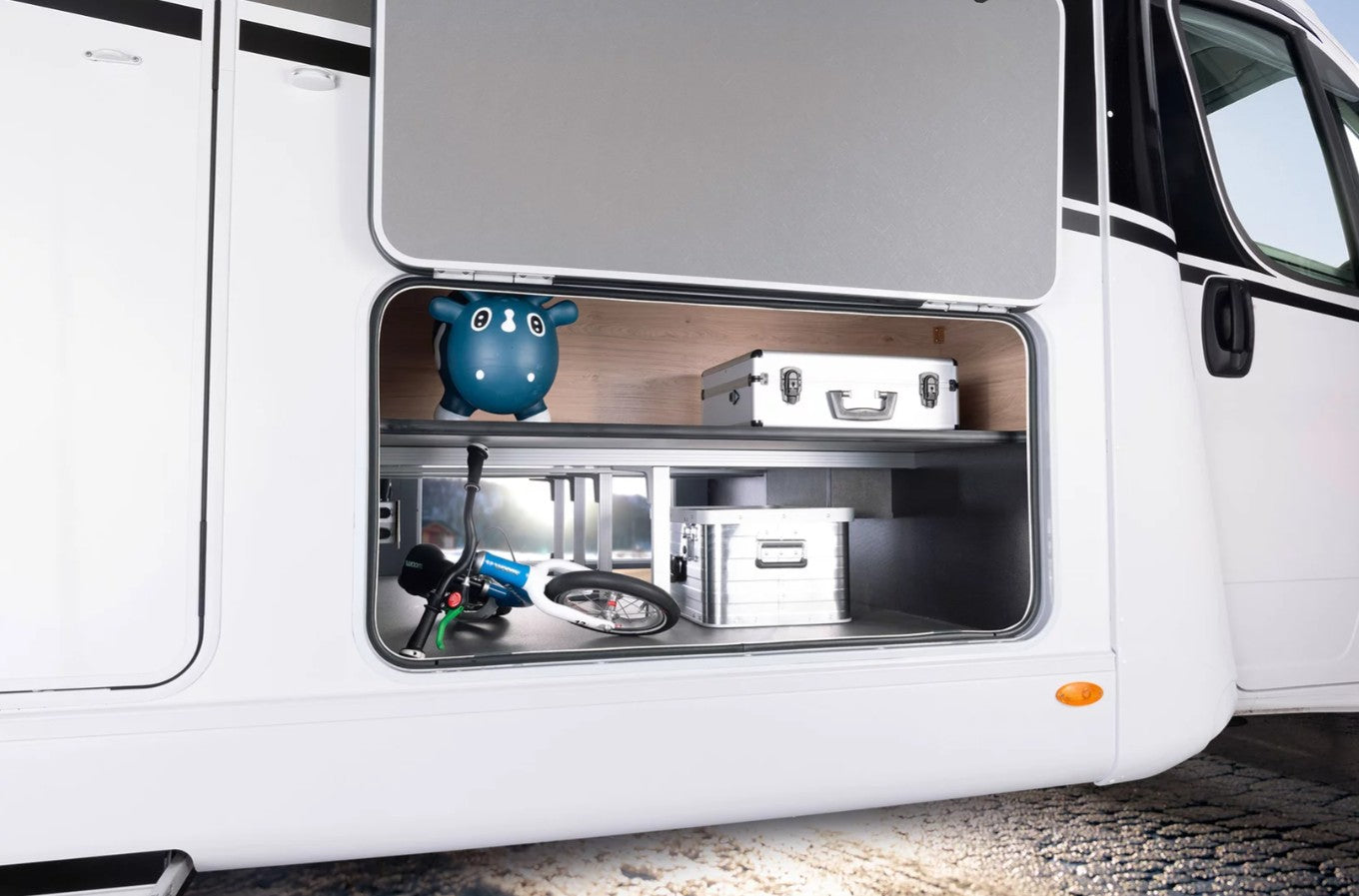An aluminium Dethleffs motorhome storage box with branded stickers in a motorhome.