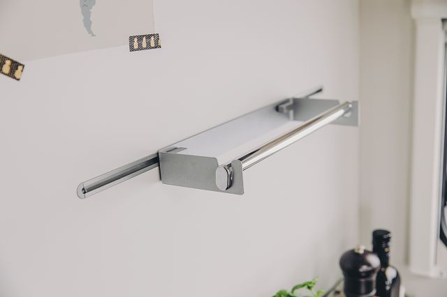 A brushed stainless steel Sunlight motorhome kitchen roll holder.