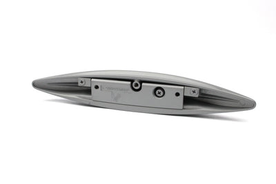 A silver wing-shaped Roller Team motorhome cupboard door handle.