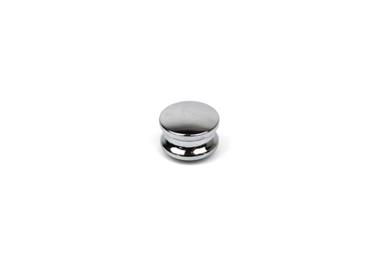 Chrome push button knob on a white background