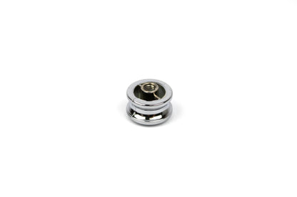 Chrome push button knob on a white background