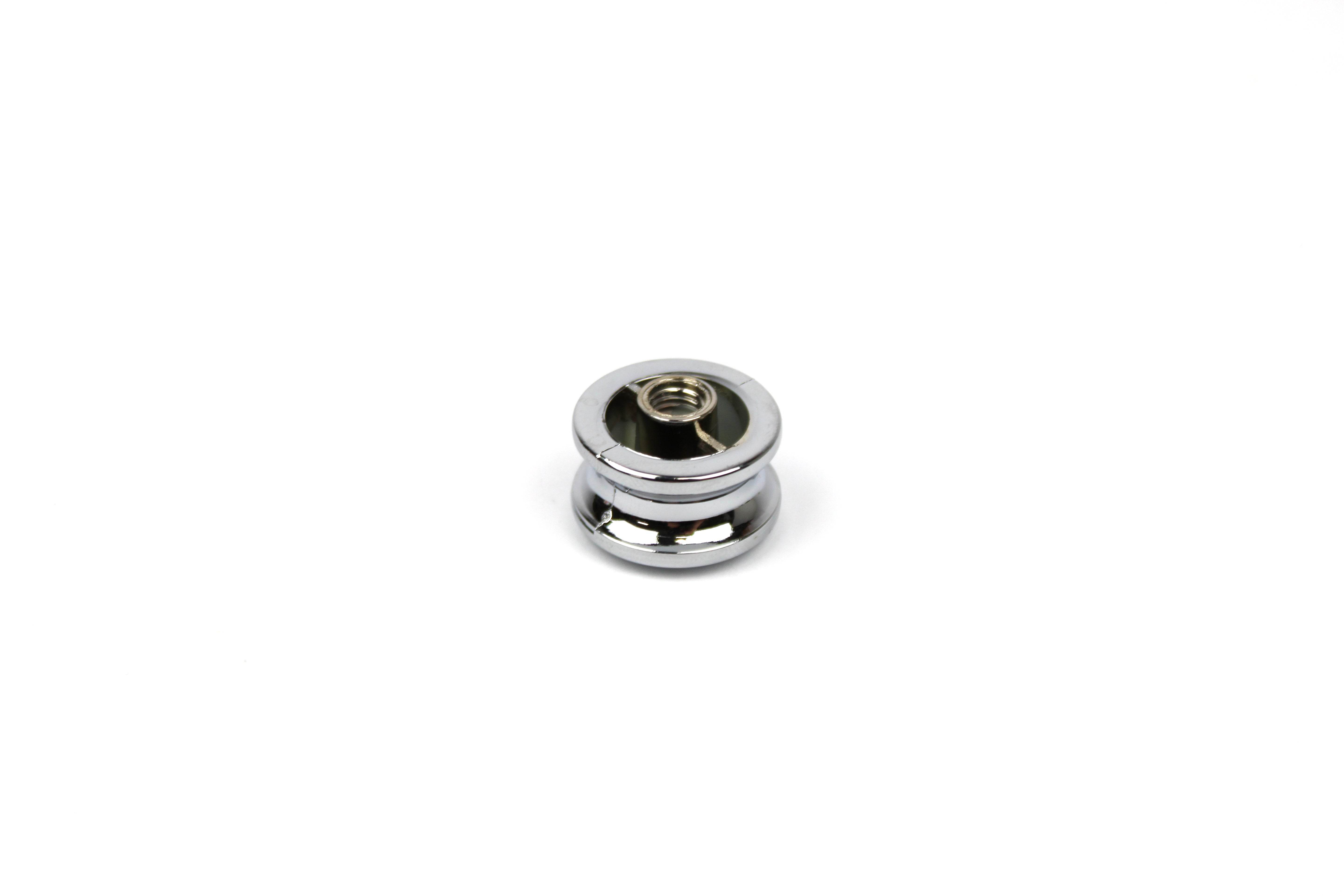 Chrome push button knob on a white background