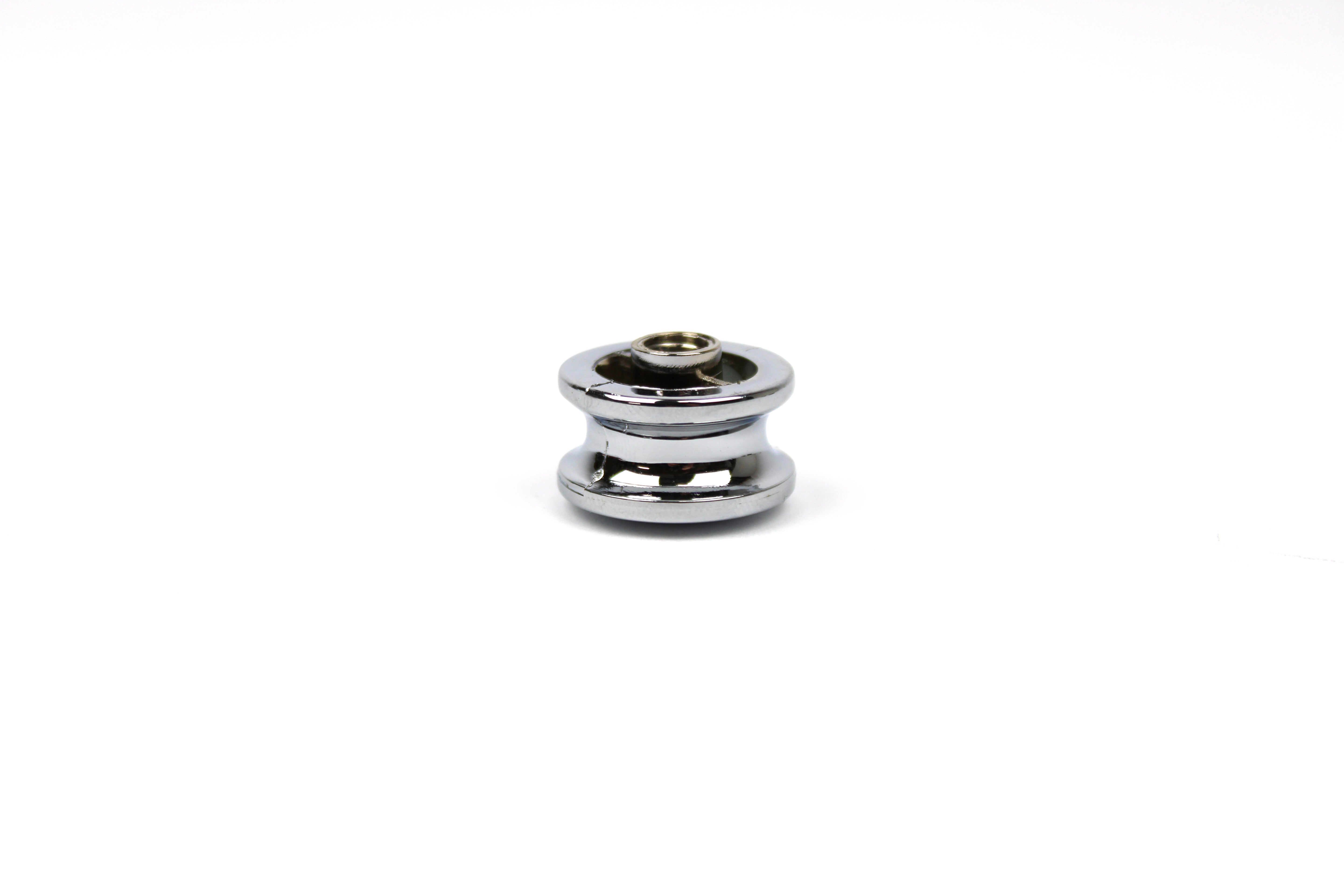 Chrome push button knob on a white background