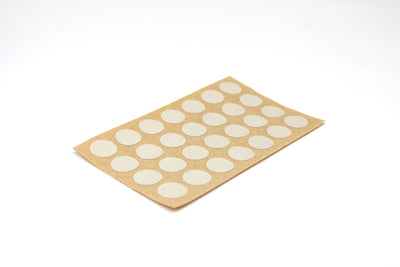 A sheet of casino pebble grey Dethleffs self-adhesive dot stickers on a beige backing.