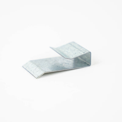 A silver metal Auto-Trail motorhome wheel arch clip.