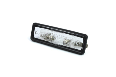 A clear Dethleffs motorhome rear number plate light with a black rim.