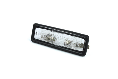 A clear Dethleffs motorhome rear number plate light with a black rim.