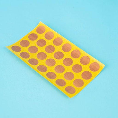 A sheet of topaz apfel / cypress villa Dethleffs self-adhesive dot stickers on a yellow backing.