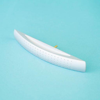 A silver arch-shaped Roller Team motorhome cupboard door handle.