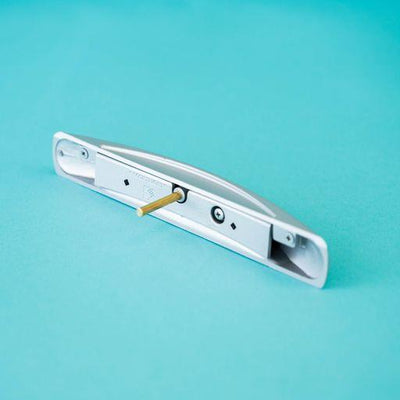A silver arch-shaped Roller Team motorhome cupboard door handle.