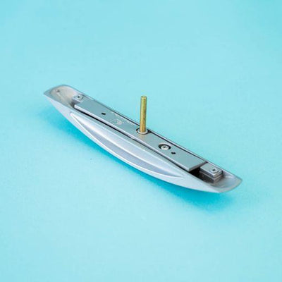A silver arch-shaped Roller Team motorhome cupboard door handle.