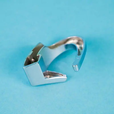 A silver Dethleffs D coat hook.