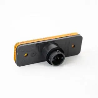 An amber Roller Team motorhome rectangular side marker light.