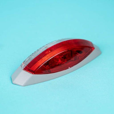 A red Dethleffs motorhome nearside side marker light.