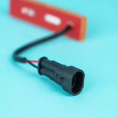A rectangular amber Dethleffs motorhome side marker light.