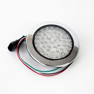 A clear Roller Team motorhome reverse light with a chrome bezel.