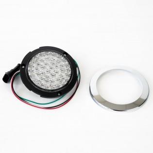 A clear Roller Team motorhome reverse light with a chrome bezel.